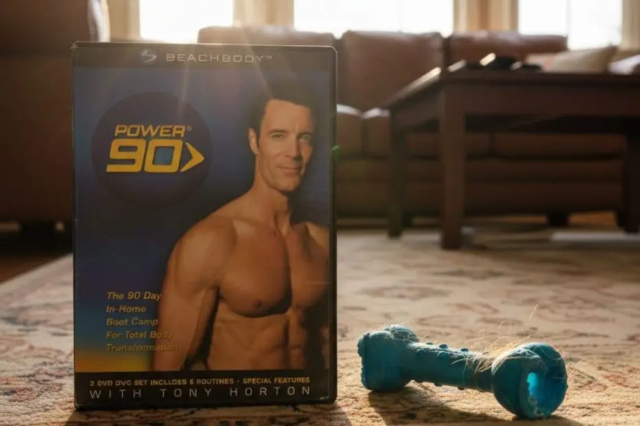A Power 90 workout DVD case sits on a rug next to a dog toy, symbolizing the start of a post-cancer fitness journey.
